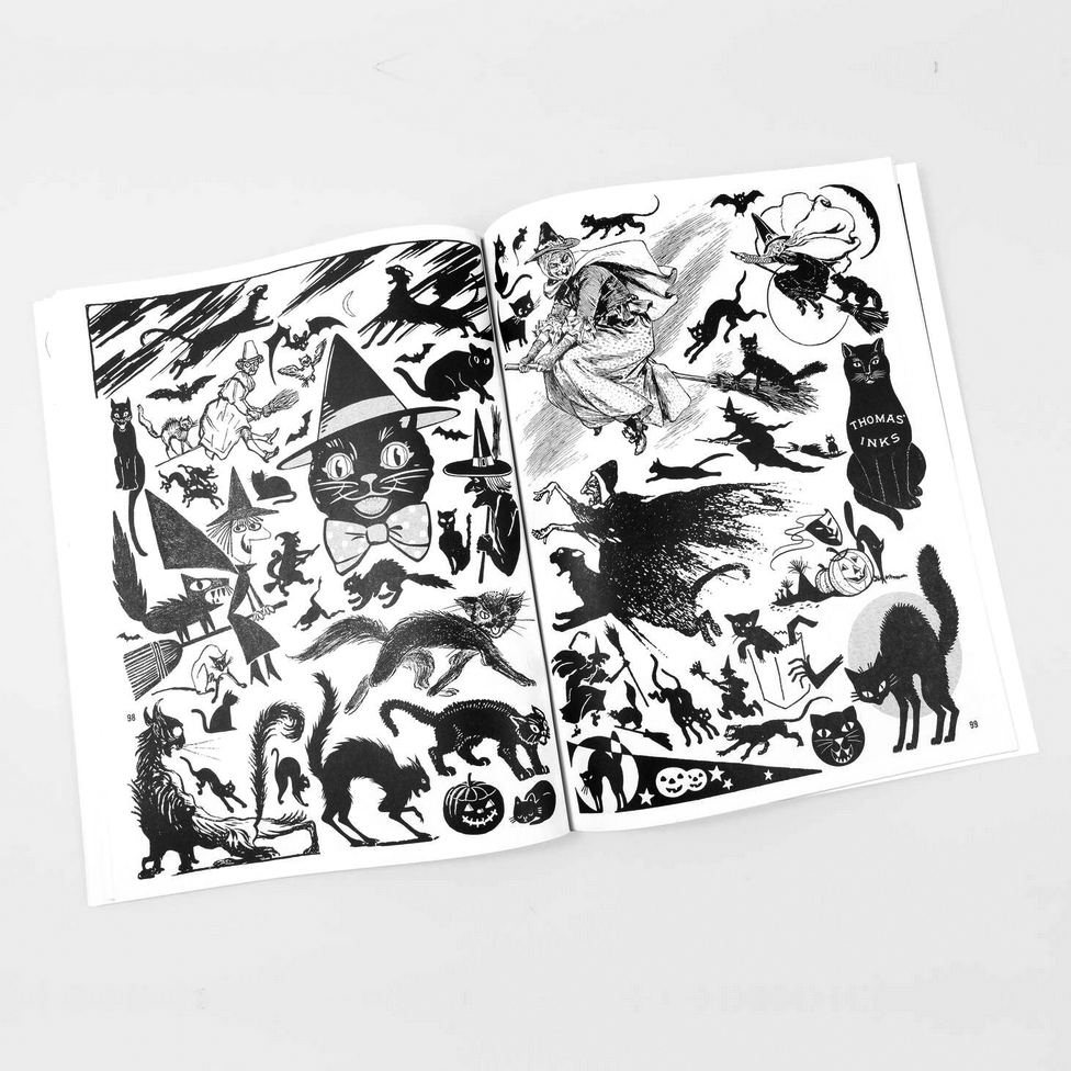 Open book with black and white illustrations of cats on a white background