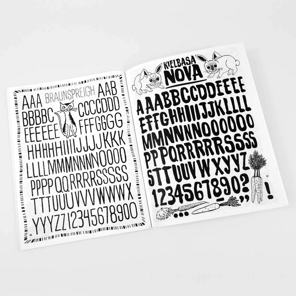 Open book of alphabet and number fonts with animal illustrations on a white background