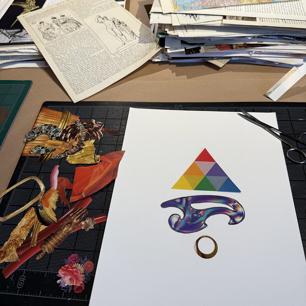 Colorful geometric design on a white sheet of paper and art supplies in the background.