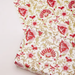 Red and pink flowers with green leaves on white background used as a gift wrap and also shown with flat sheet