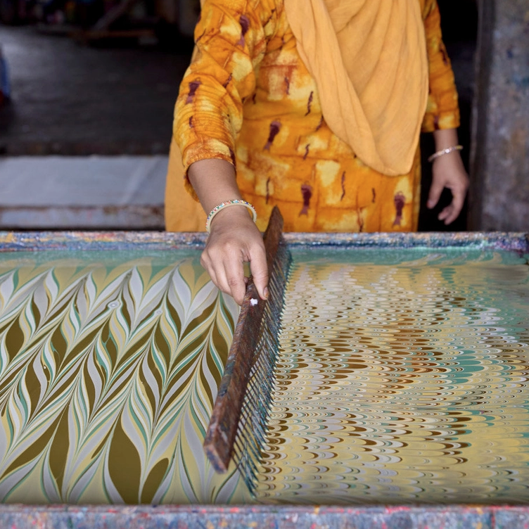 Handmade Indian Cotton Paper- Marbling work in progress. combing the pattern into the paint