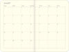 An open monthly calendar spread showing June 2027, with a cream-colored page, black printed day labels, and a double-page layout.