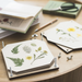 Flower Press shown open on a table with pressed flowers