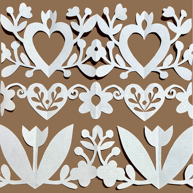 White paper cutout decorative border with hearts, flowers, leaves, and tulips arranged in horizontal rows on a solid brown background.