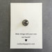 Back side of card showing pin back